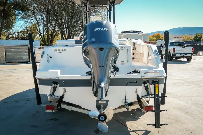 Slide: The Image of 2020 Robalo R242 Center Console boat with Yamaha 300 engine, parked outdoors. - 8