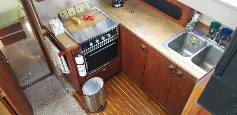 Slide: The Image of 1989 Bayliner 3888 Motoryacht kitchen with stove and sink. - 11