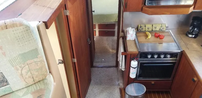 Slide: The Image of Interior of 1989 Bayliner 3888 Motoryacht with kitchen and living area. - 12