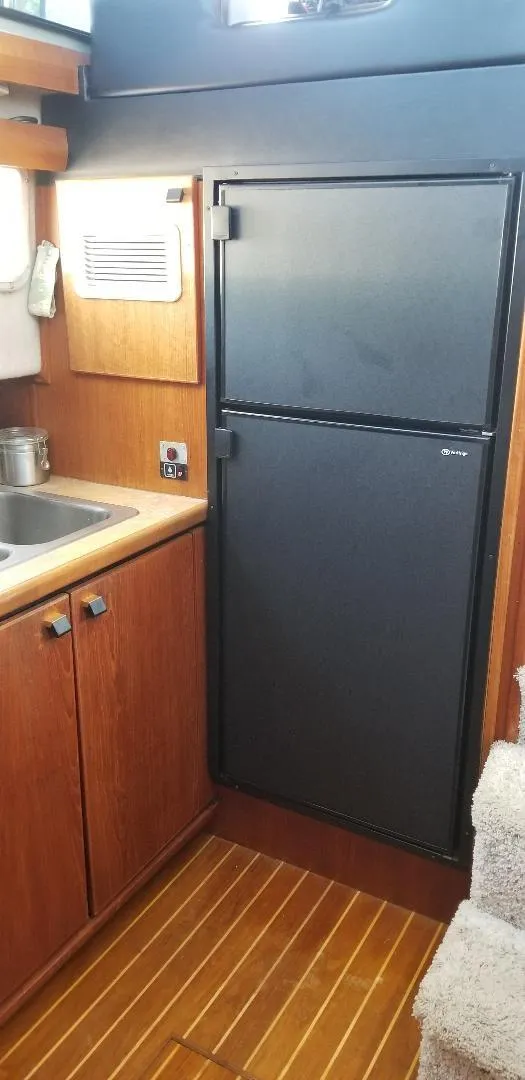 Slide: The Image of 1989 Bayliner 3888 Motoryacht kitchen area with refrigerator. - 13