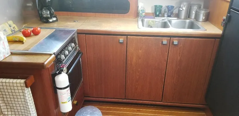 Slide: The Image of 1989 Bayliner 3888 Motoryacht kitchen with wooden cabinets. - 14