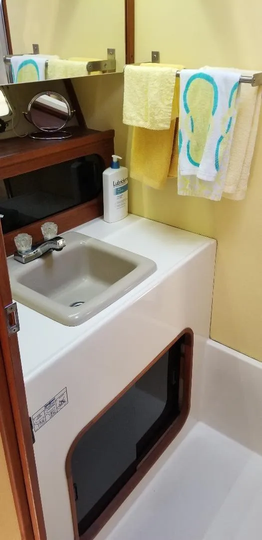 Slide: The Image of 1989 Bayliner 3888 Motoryacht bathroom with sink and towels. - 16