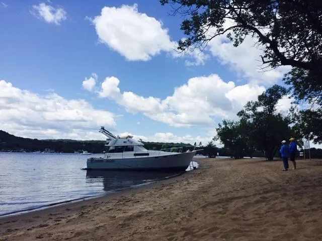 Slide: The Image of 1989 Bayliner 3888 Motoryacht on sandy shore under blue sky. - 2