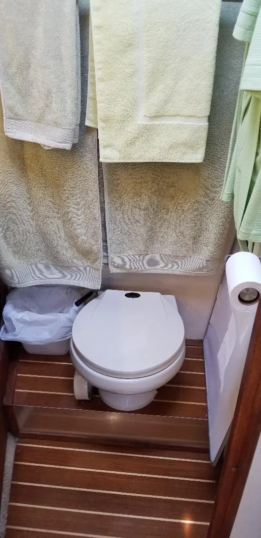 Slide: The Image of 1989 Bayliner 3888 Motoryacht bathroom with toilet and towels. - 24