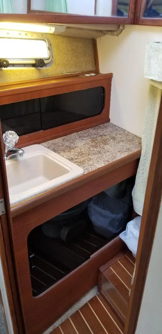 Slide: The Image of 1989 Bayliner 3888 Motoryacht interior with sink and storage area. - 25