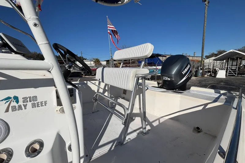 Slide: The Image of 2001 Key West 210 Bay Reef boat with Yamaha 225 engine, white seating, and American flag. - 14
