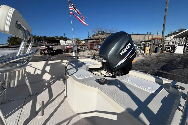 Slide: The Image of 2001 Key West 210 Bay Reef boat with Yamaha engine, American flag in background. - 15