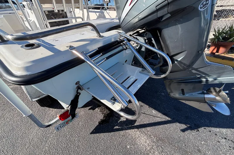 Slide: The Image of 2001 Key West 210 Bay Reef boat with stainless steel swim ladder and outboard motor. - 17