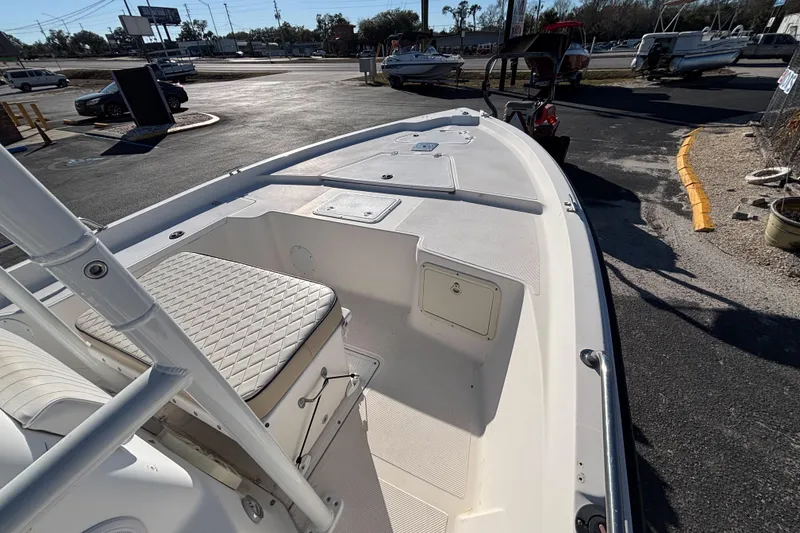 Slide: The Image of 2001 Key West 210 Bay Reef boat, white interior, parked outdoors in a lot. - 25