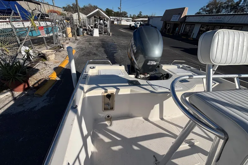 Slide: The Image of 2001 Key West 210 Bay Reef boat with Yamaha 225 engine in a marina setting. - 27