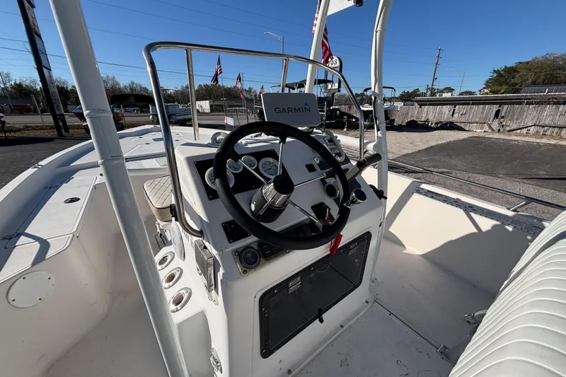 Slide: The Image of 2001 Key West 210 Bay Reef boat cockpit with Garmin navigation system and steering wheel. - 28