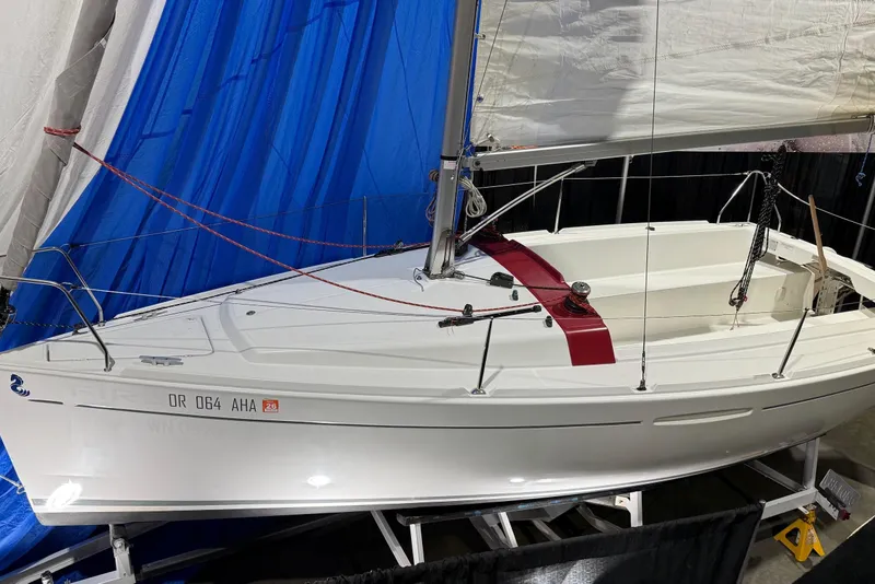 The Image of 2016 Beneteau First 22 sailboat displayed indoors with blue backdrop. - 0