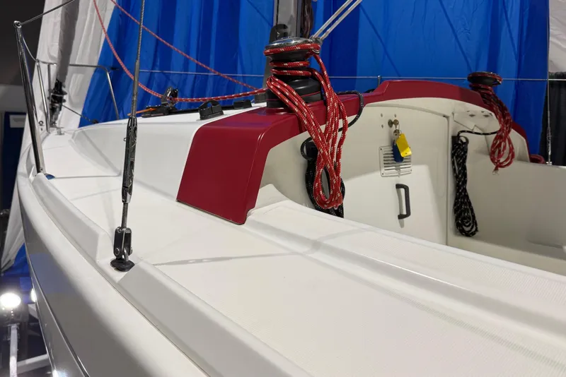 Slide: The Image of 2016 Beneteau First 22 sailboat deck with red rigging and blue sail backdrop. - 3