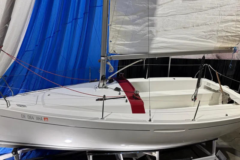 Slide: The Image of 2016 Beneteau First 22 sailboat with white hull and red accents on display. - 4