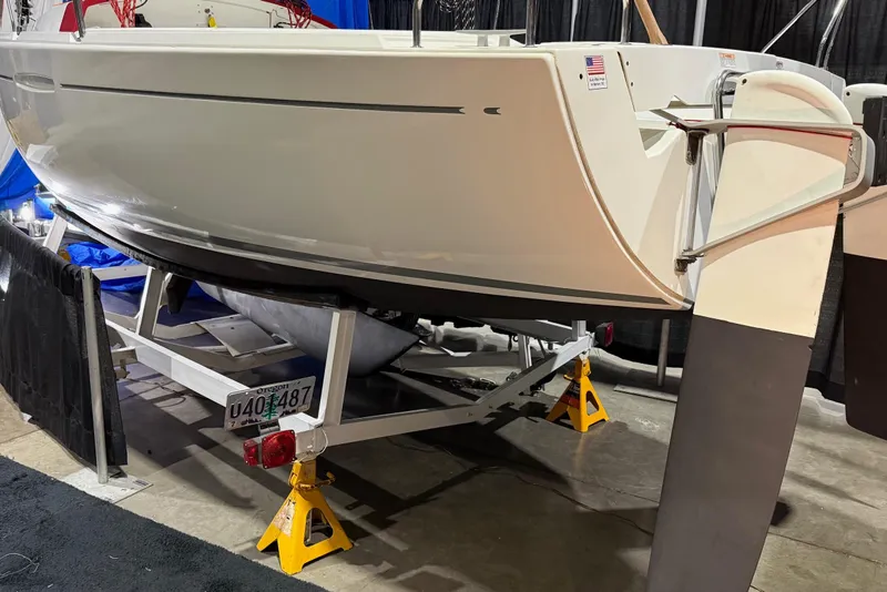 Slide: The Image of 2016 Beneteau First 22 sailboat on trailer, displayed indoors with Oregon license plate. - 5