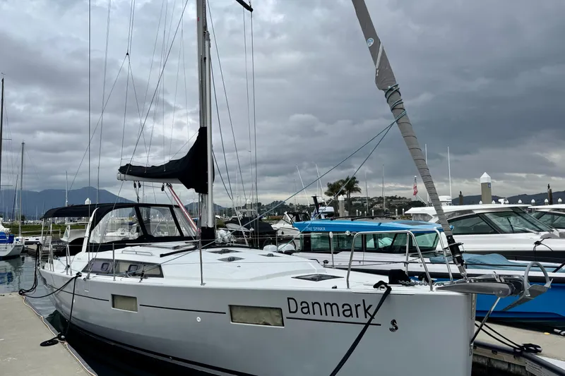 Slide: The Image of 2019 Beneteau Oceanis 41.1 sailboat docked at marina under cloudy skies. - 0