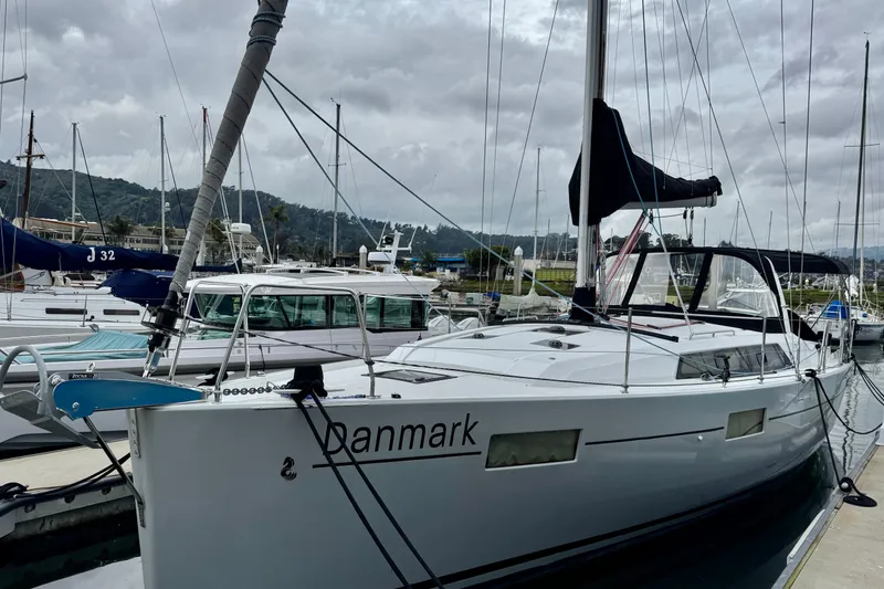 Slide: The Image of 2019 Beneteau Oceanis 41.1 sailboat docked at marina under cloudy sky. - 1