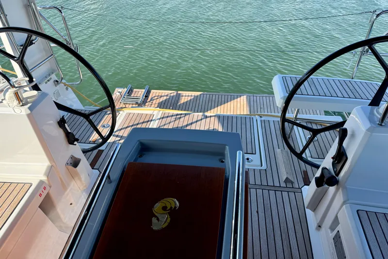 Slide: The Image of 2019 Beneteau Oceanis 41.1 yacht cockpit with dual steering wheels and teak decking. - 16