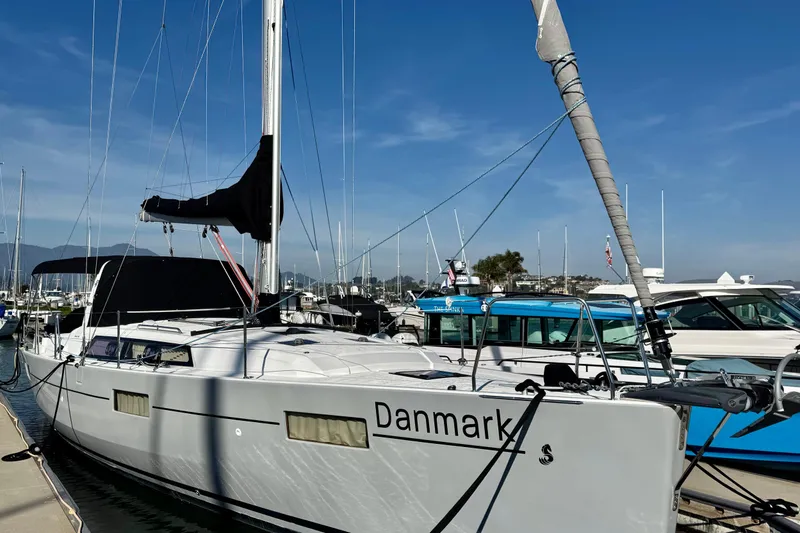 Slide: The Image of 2019 Beneteau Oceanis 41.1 sailboat docked in a marina under clear blue skies. - 2