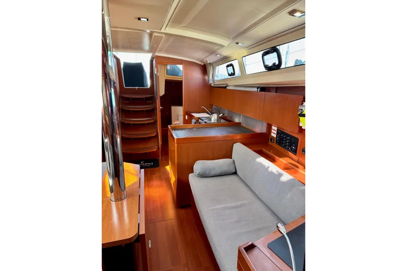 Slide: The Image of Interior of 2019 Beneteau Oceanis 41.1 yacht with modern wood finish and cozy seating. - 29