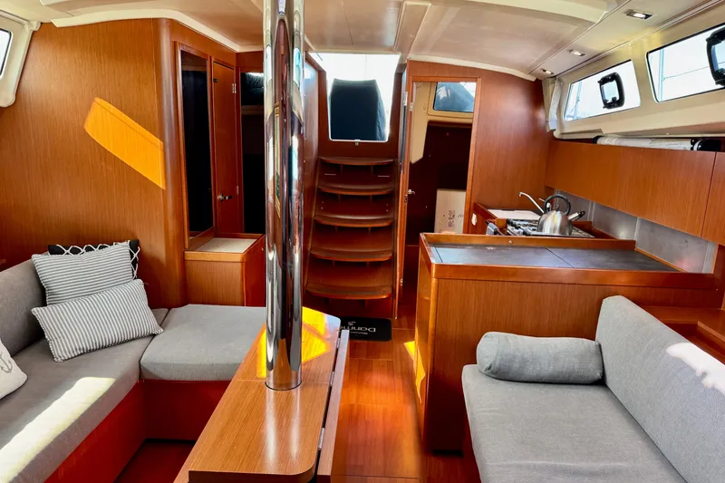 Slide: The Image of Interior of 2019 Beneteau Oceanis 41.1 yacht with modern wood finish and cozy seating. - 30