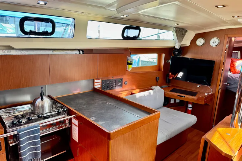 Slide: The Image of 2019 Beneteau Oceanis 41.1 interior with modern kitchen, seating, and entertainment area. - 32