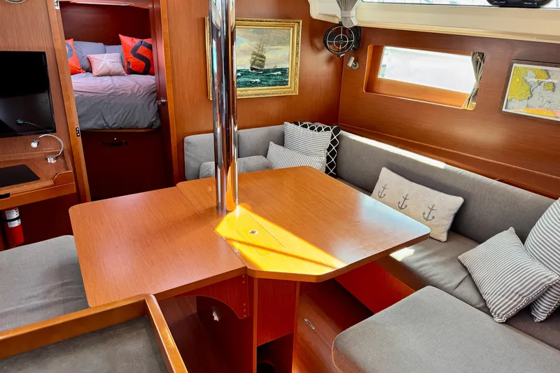 Slide: The Image of Interior of 2019 Beneteau Oceanis 41.1 yacht with cozy seating and nautical decor. - 36