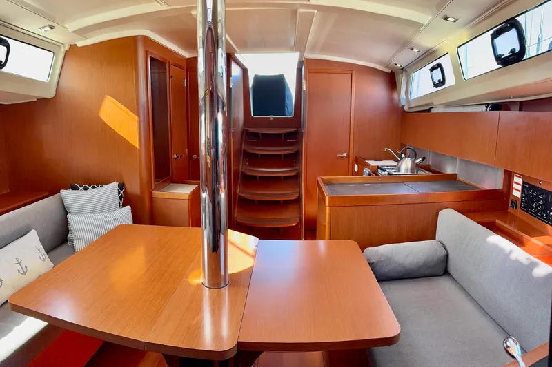 Slide: The Image of Interior of 2019 Beneteau Oceanis 41.1 yacht with modern wood finish and cozy seating. - 42