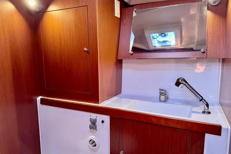 Slide: The Image of 2019 Beneteau Oceanis 41.1 yacht bathroom with wooden cabinetry and modern sink. - 48