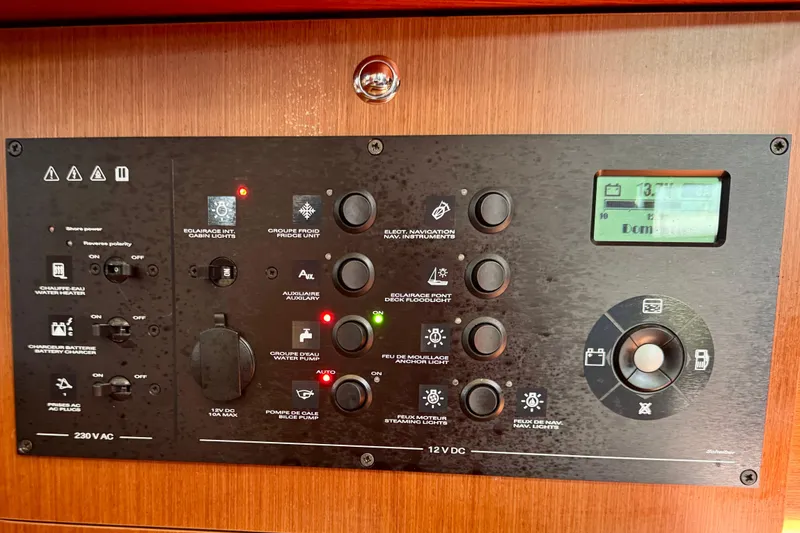 Slide: The Image of Control panel of a 2019 Beneteau Oceanis 41.1 yacht, featuring various switches and indicators. - 54