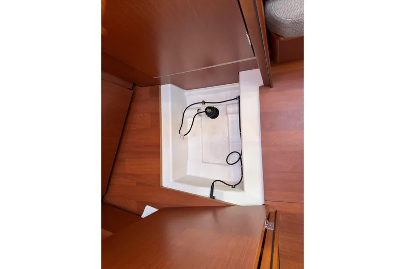 Slide: The Image of Bilge compartment of 2019 Beneteau Oceanis 41.1 sailboat with visible pump and wiring. - 61