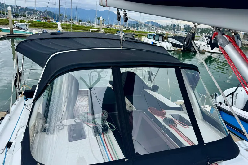 Slide: The Image of 2019 Beneteau Oceanis 41.1 sailboat docked, featuring a sleek black canopy and modern design. - 7
