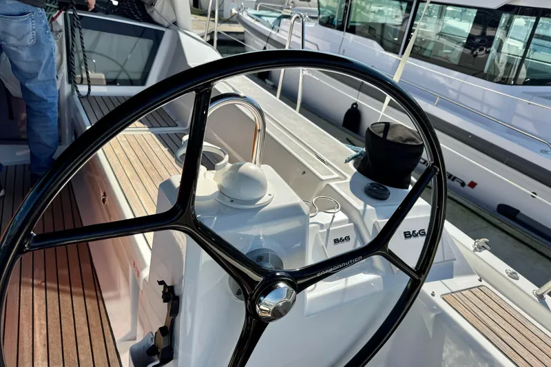Slide: The Image of Steering wheel of 2019 Beneteau Oceanis 41.1 sailboat, docked with visible deck details. - 9