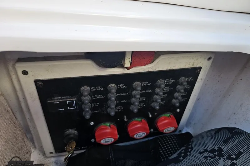 Slide: The Image of Control panel of a 2008 Donzi 27 ZR boat with switches and hour meter. - 102