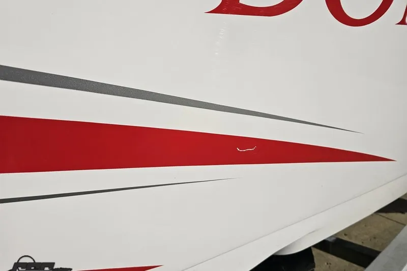 Slide: The Image of 2008 Donzi 27 ZR boat with red and gray stripe design on white hull. - 14