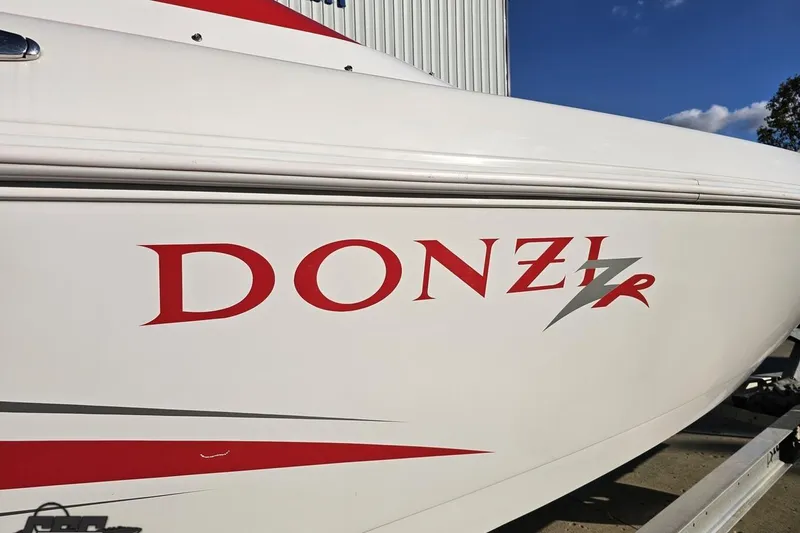 Slide: The Image of 2008 Donzi 27 ZR boat with bold red logo on white hull. - 15