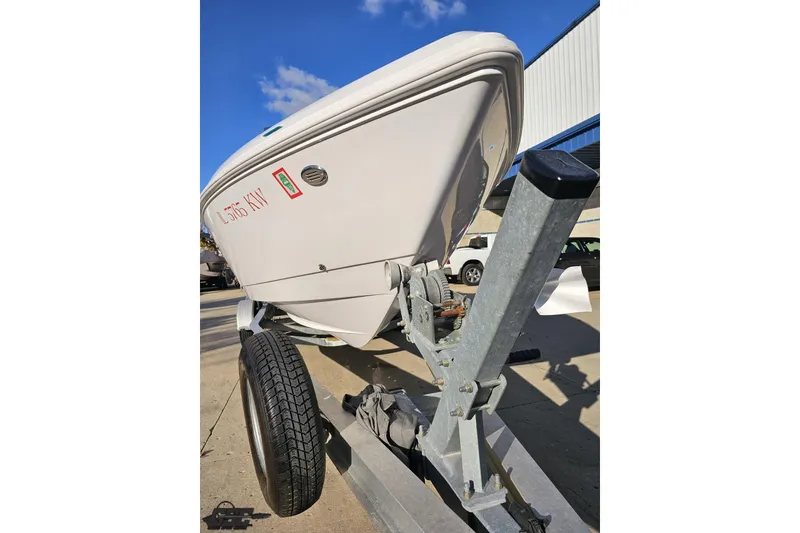 Slide: The Image of 2008 Donzi 27 ZR boat on trailer, parked outdoors under clear blue sky. - 19