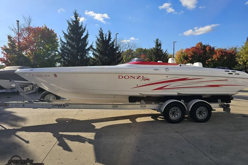 Slide: The Image of 2008 Donzi 27 ZR speedboat on trailer, parked outdoors under a clear sky. - 24
