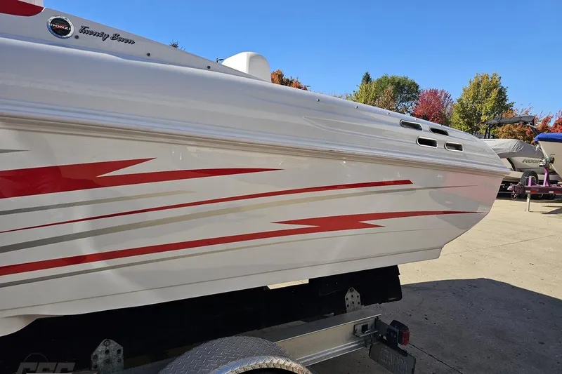 Slide: The Image of 2008 Donzi 27 ZR boat with red and gray graphics on a trailer. - 28