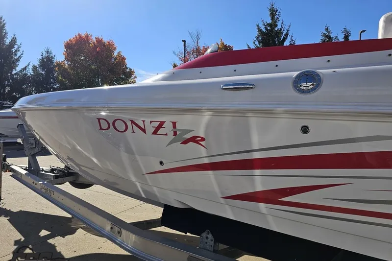 Slide: The Image of 2008 Donzi 27 ZR boat with red and white design on trailer. - 30