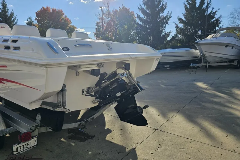 Slide: The Image of 2008 Donzi 27 ZR boat on trailer, parked outdoors with other boats nearby. - 33