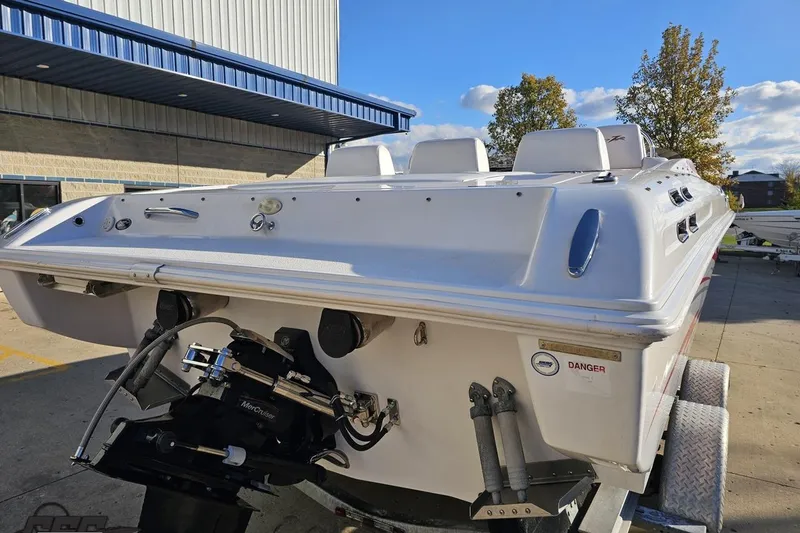 Slide: The Image of 2008 Donzi 27 ZR boat on trailer, rear view, sunny day, industrial background. - 35