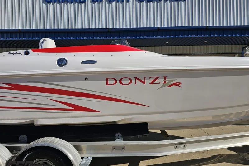 Slide: The Image of 2008 Donzi 27 ZR speedboat with red accents on a trailer. - 4