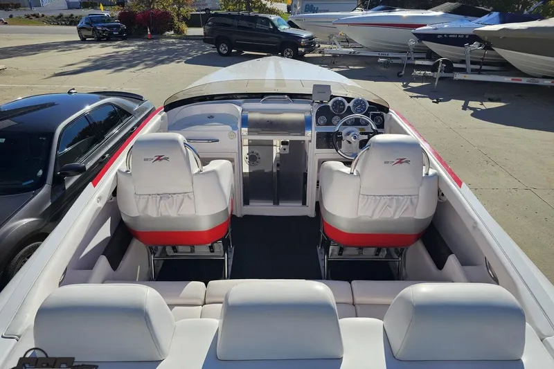 Slide: The Image of 2008 Donzi 27 ZR boat interior with white and red seating, dashboard, and steering wheel. - 46