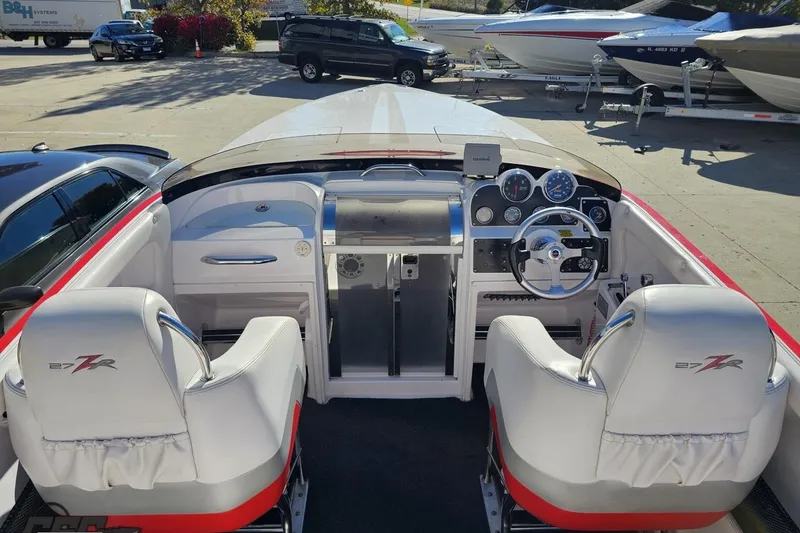 Slide: The Image of 2008 Donzi 27 ZR boat interior with steering wheel and dashboard controls. - 47