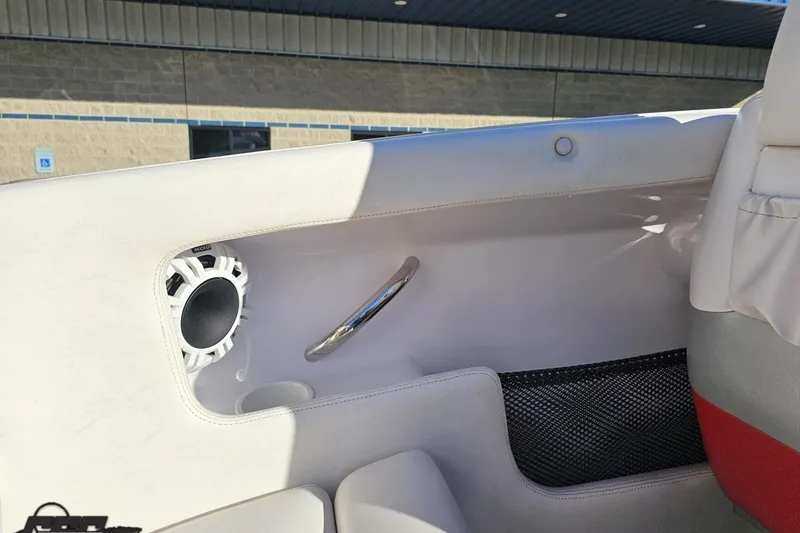 Slide: The Image of Interior of a 2008 Donzi 27 ZR boat, featuring speaker and storage net. - 57