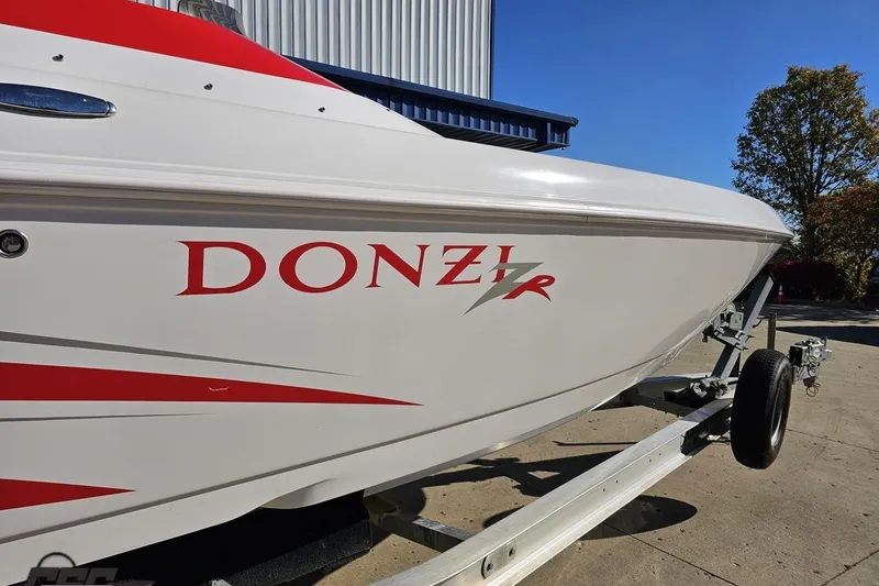 Slide: The Image of 2008 Donzi 27 ZR boat on trailer, featuring sleek red and white design. - 6