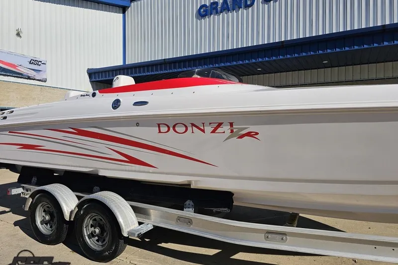 Slide: The Image of 2008 Donzi 27 ZR speedboat on trailer, featuring sleek red and white design. - 7