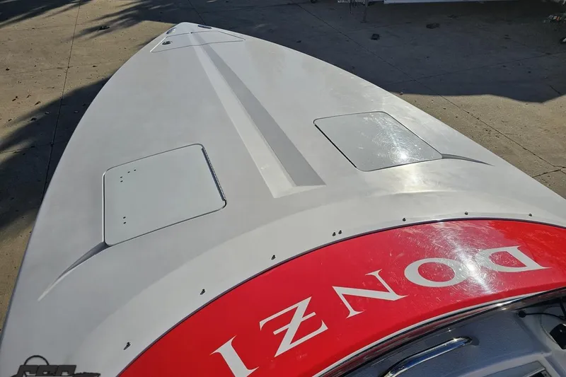 Slide: The Image of 2008 Donzi 27 ZR boat deck with red branding, viewed from above. - 70