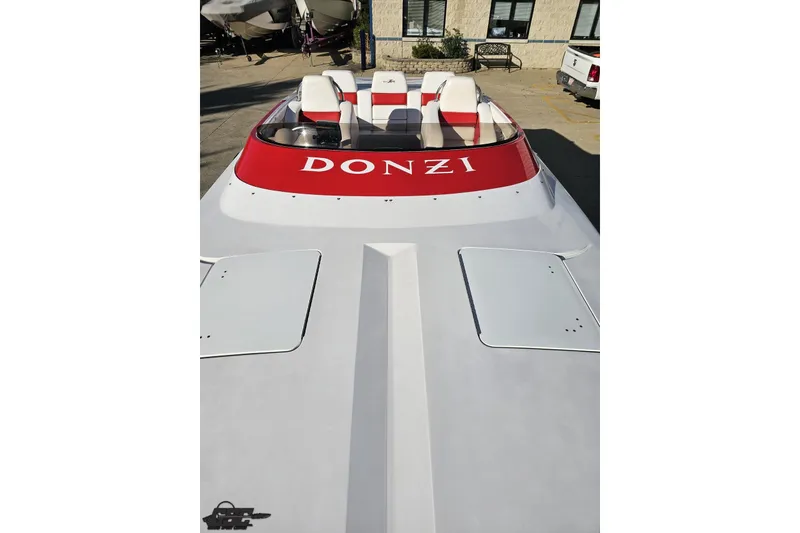 Slide: The Image of 2008 Donzi 27 ZR speedboat with red accents, parked outdoors. - 73